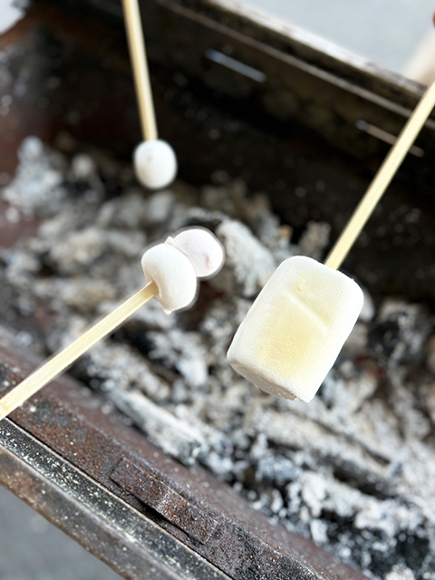 竹串に刺したマシュマロを、炭火の遠火でじっくりと炙り、表面に焼き色をつけているデザートタイム。